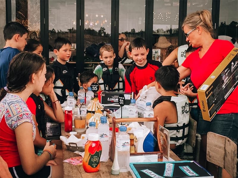 A school group gathered at the lakeside café between activities
