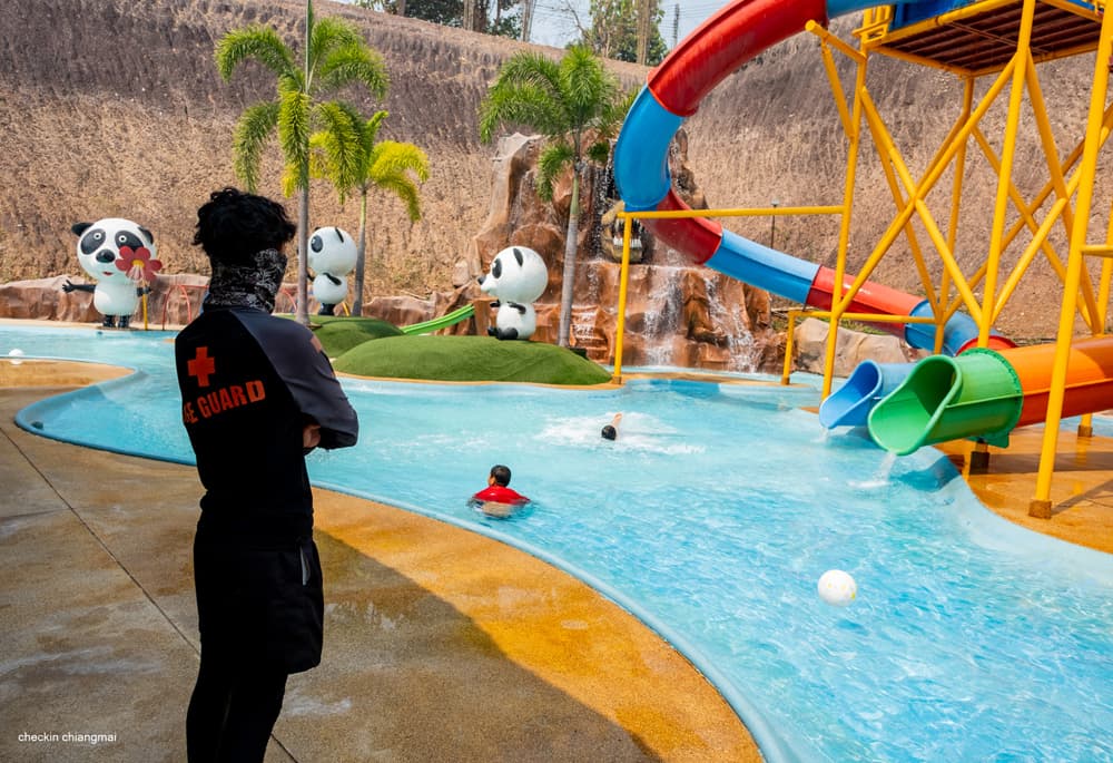 Multi-lane water slides spilling into the lake beside the panda kids zone